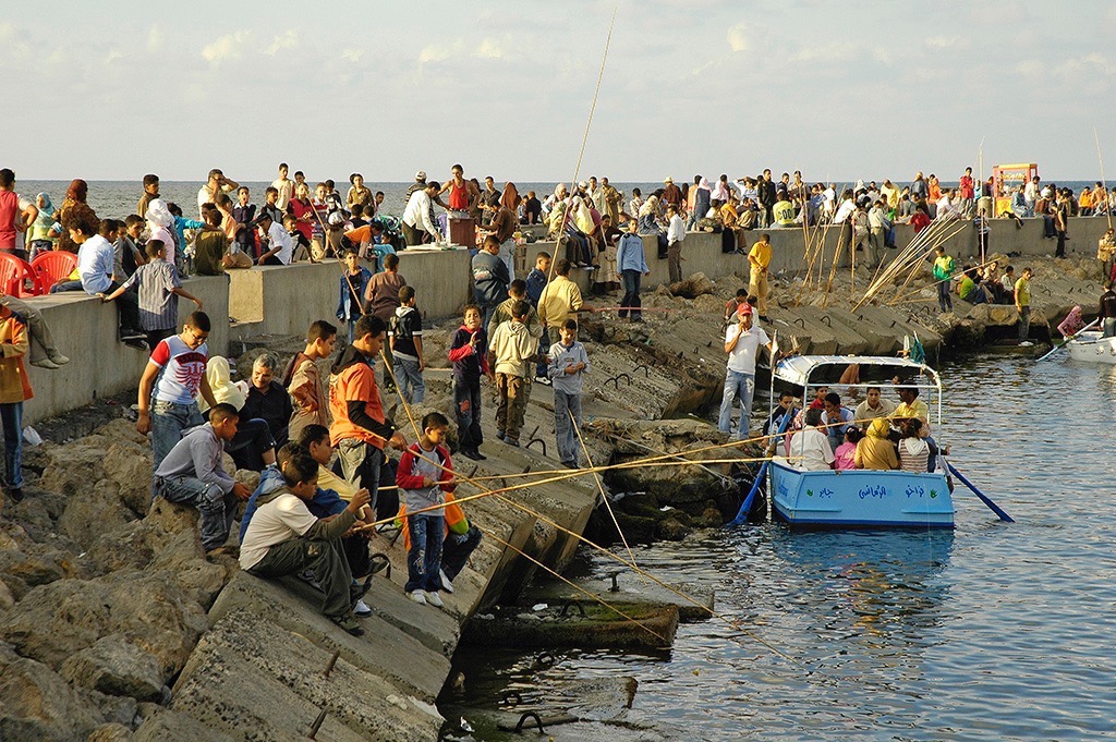  Fishing off the breakwater during Feast of Eid. 
