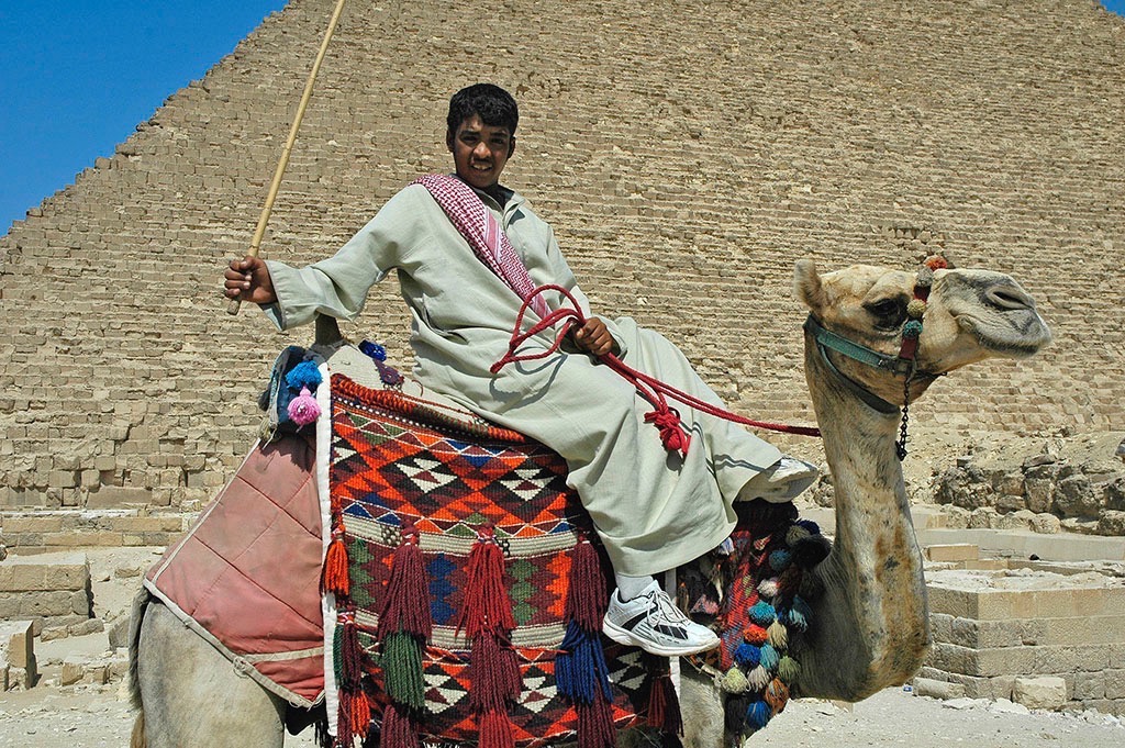  Young man and camel at the foot of Khufu’s pyramid. 